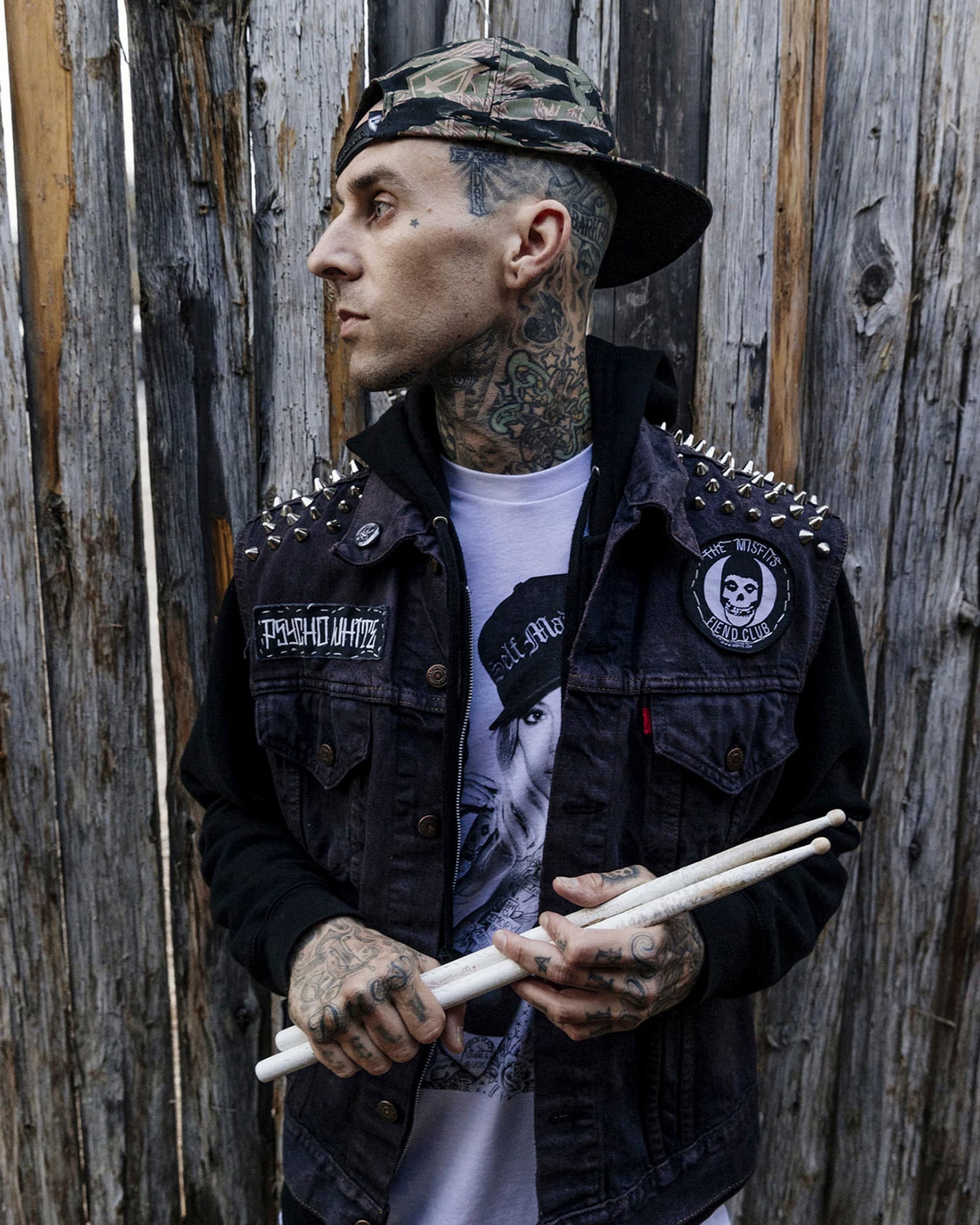 Environmental portrait of Travis Barker with drumsticks