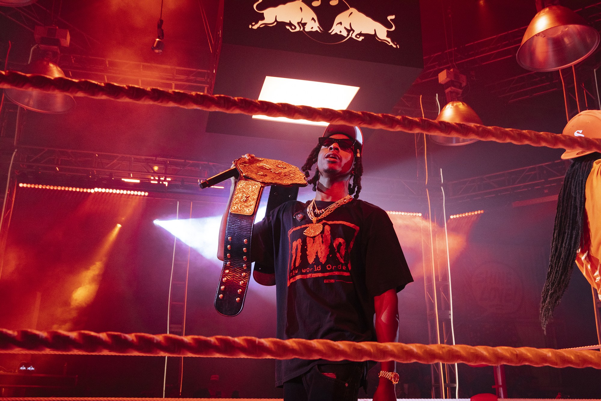 Joey Bada$$ holding a championship belt in the ring at Red Bull x Zeltron Worldwide